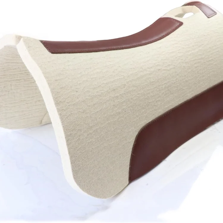 Horse saddle pad with beige fabric and brown leather accents on a white surface